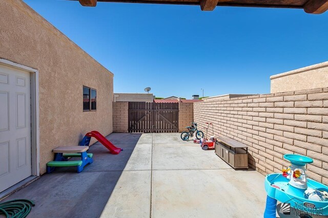 543 E 25th St, Yuma, AZ 85365 - fenced backyard with a patio area and a gate