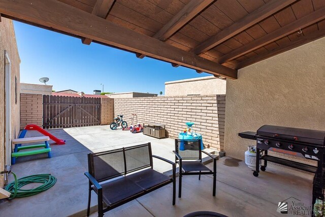 543 E 25th St, Yuma, AZ 85365 - fenced backyard with a patio, a grill, and a gate