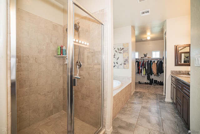 4387 W 24th Pl, Yuma, AZ 85364 - full bath with a garden tub, a shower stall, vanity, and a walk in closet