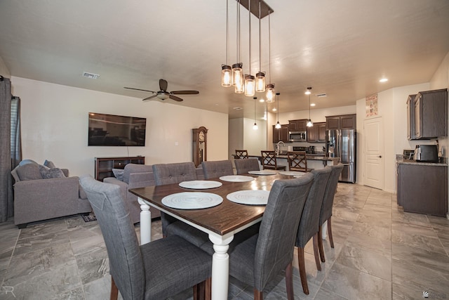 4387 W 24th Pl, Yuma, AZ 85364 - dining room featuring ceiling fan and light marble finish flooring