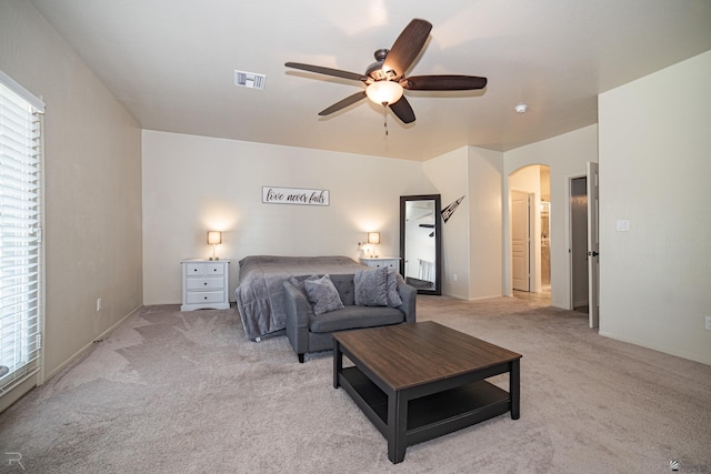 4387 W 24th Pl, Yuma, AZ 85364 - bedroom featuring arched walkways, light carpet, multiple windows, and a ceiling fan