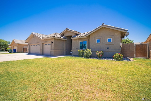 4387 W 24th Pl, Yuma, AZ 85364 - view of front facade with a garage, concrete driveway, stucco siding, a gate, and a tiled roof