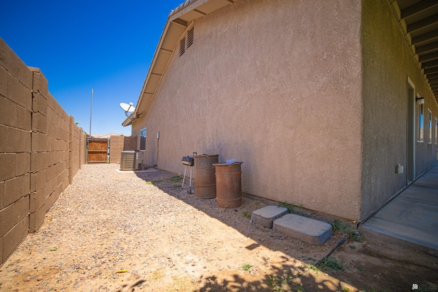 4387 W 24th Pl, Yuma, AZ 85364 - view of side of property with a central AC unit and stucco siding