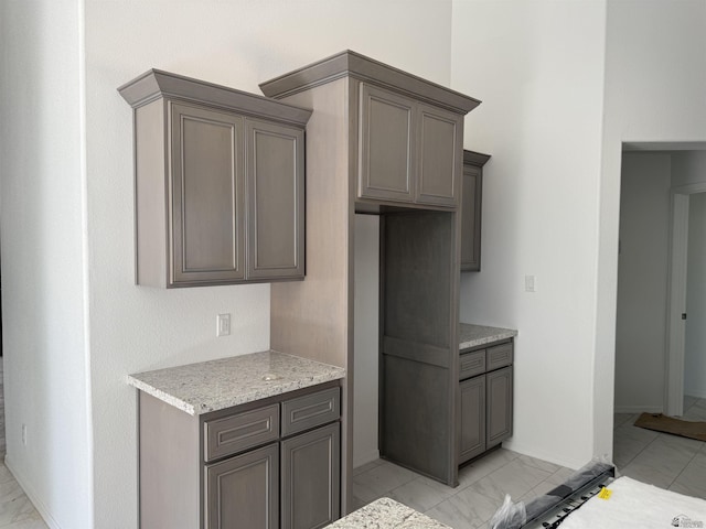 10857 E 45th Pl, Yuma, AZ 85367 - kitchen featuring light marble finish flooring and light stone counters