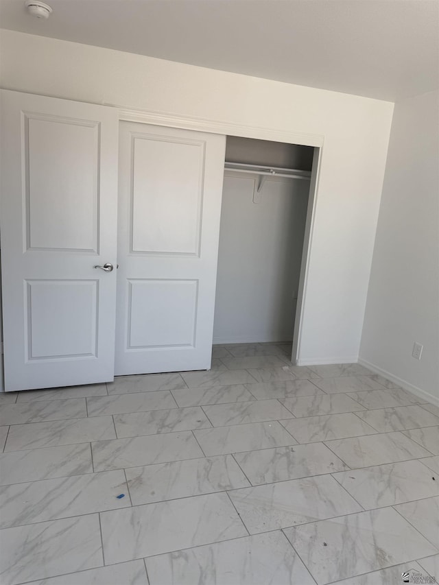 10857 E 45th Pl, Yuma, AZ 85367 - unfurnished bedroom with light marble finish floors and a closet