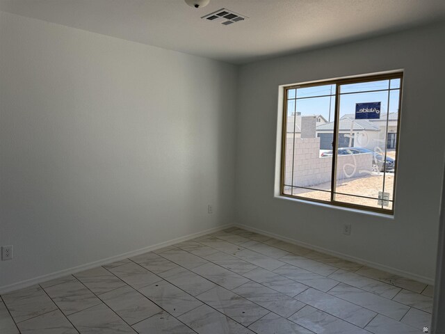 10857 E 45th Pl, Yuma, AZ 85367 - unfurnished room with light marble finish floors and baseboards