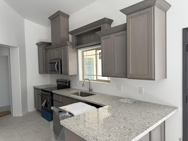 10857 E 45th Pl, Yuma, AZ 85367 - kitchen with appliances with stainless steel finishes, a peninsula, and light stone counters