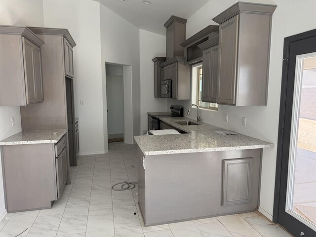 10857 E 45th Pl, Yuma, AZ 85367 - kitchen featuring light marble finish flooring, electric range oven, a peninsula, light stone countertops, and stainless steel microwave