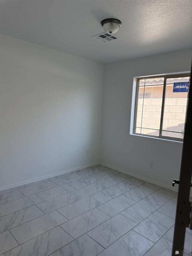 10857 E 45th Pl, Yuma, AZ 85367 - empty room featuring light marble finish flooring and a textured ceiling