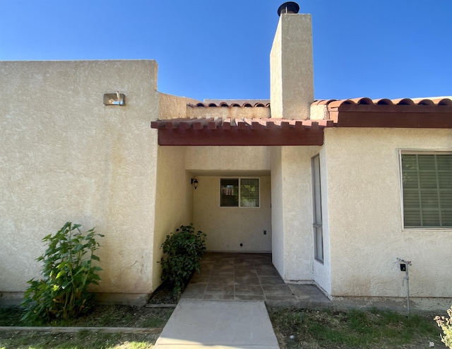 1700 S Crowder Ave, Yuma, AZ 85364 - doorway to property with stucco siding and a tile roof
