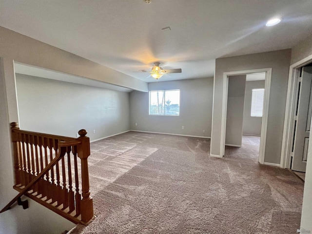 basement with carpet floors and ceiling fan