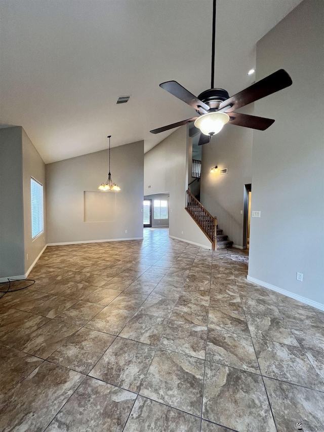 unfurnished living room featuring ceiling fan and high vaulted ceiling