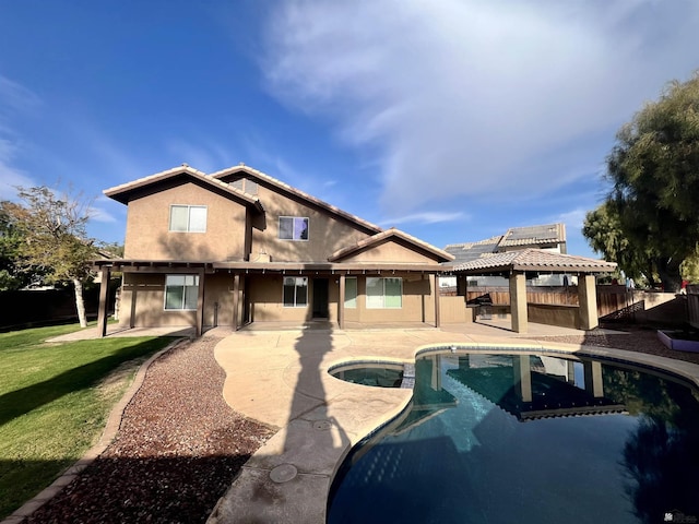 back of house featuring a gazebo, a fenced in pool, and a patio area