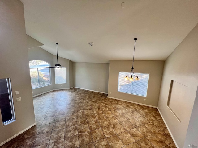 unfurnished dining area with vaulted ceiling and ceiling fan with notable chandelier