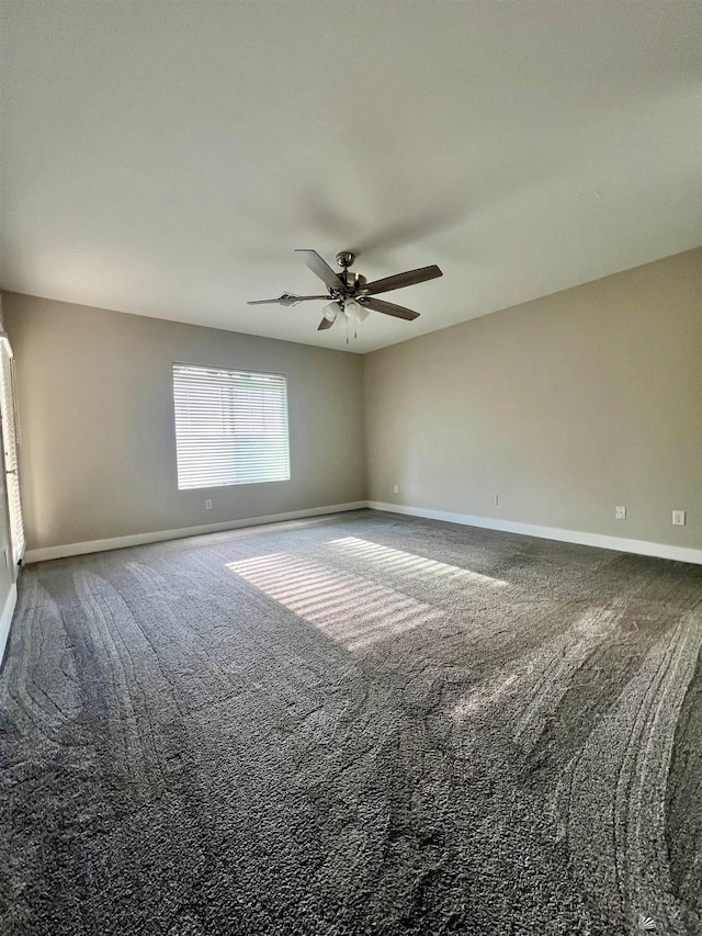 empty room with ceiling fan and carpet flooring