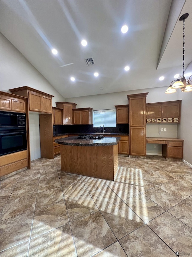 kitchen featuring lofted ceiling, hanging light fixtures, a center island, a notable chandelier, and black appliances