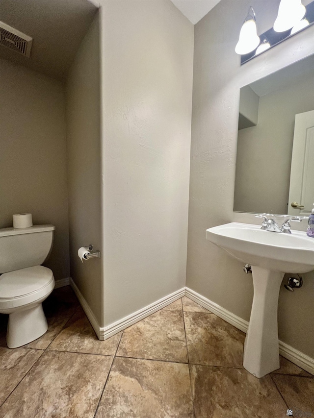 bathroom with sink, tile patterned floors, and toilet