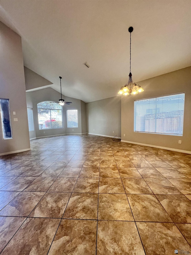 interior space with lofted ceiling, ceiling fan with notable chandelier, plenty of natural light, and tile patterned floors