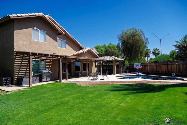 rear view of property with central AC unit, a gazebo, a patio area, and a lawn