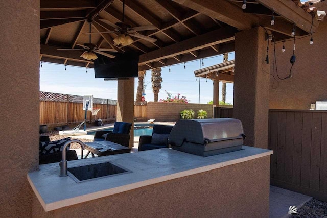 view of patio / terrace featuring ceiling fan, sink, and area for grilling