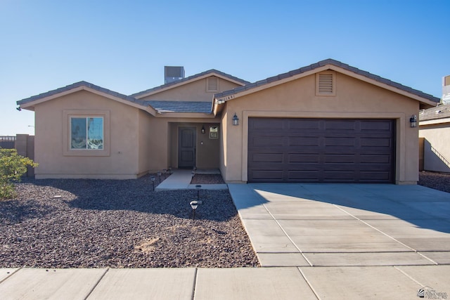 11681 E 33rd St, Yuma, AZ 85367 - single story home with a garage, stucco siding, concrete driveway, a tile roof, and cooling unit