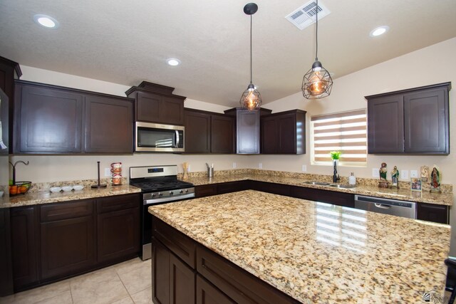 11681 E 33rd St, Yuma, AZ 85367 - kitchen featuring stainless steel appliances, a sink, dark brown cabinetry, light stone counters, and recessed lighting