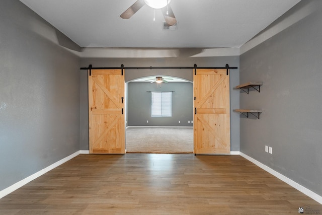 12170 E 33rd Pl, Yuma, AZ 85367 - empty room featuring a barn door, a ceiling fan, and baseboards