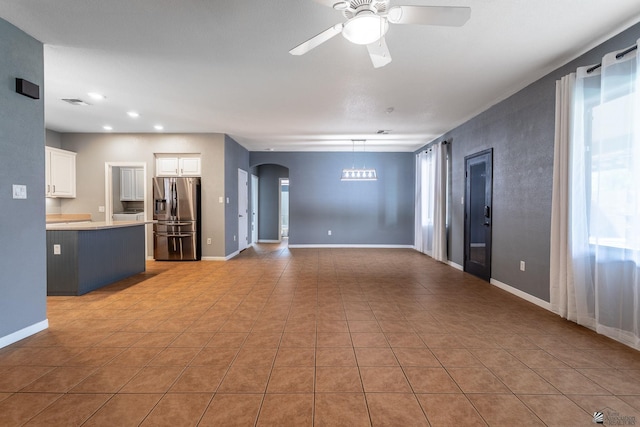 12170 E 33rd Pl, Yuma, AZ 85367 - unfurnished living room with arched walkways, ceiling fan, healthy amount of natural light, light tile patterned floors, and recessed lighting