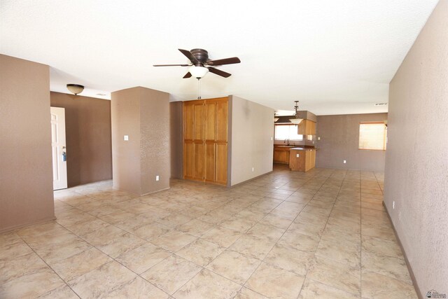 3023 W 26th St, Yuma, AZ 85364 - kitchen with white appliances, under cabinet range hood, a textured ceiling, light tile patterned flooring, and healthy amount of natural light