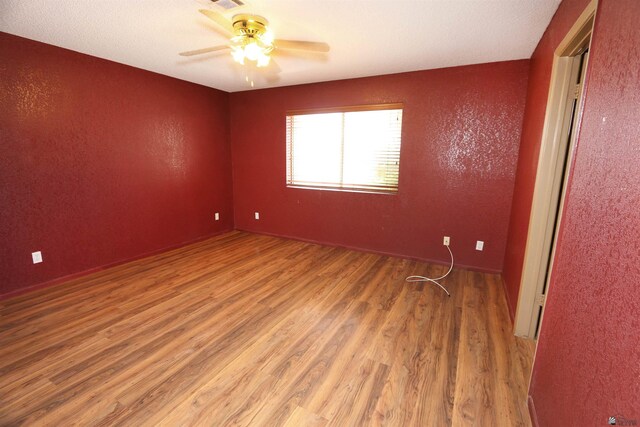 3023 W 26th St, Yuma, AZ 85364 - empty room with wood finished floors, a ceiling fan, and a textured wall