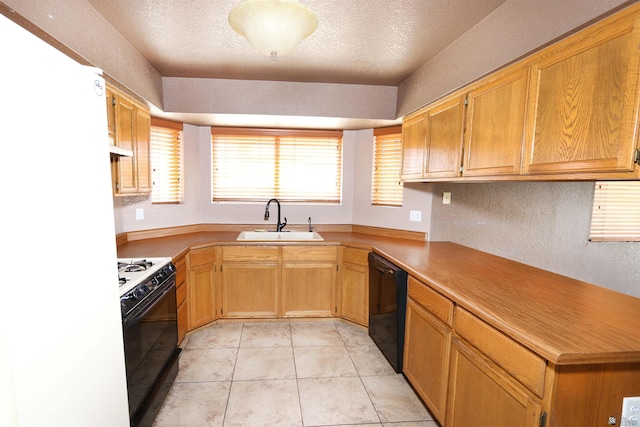3023 W 26th St, Yuma, AZ 85364 - kitchen with range with gas cooktop, black dishwasher, under cabinet range hood, a textured ceiling, and light tile patterned flooring