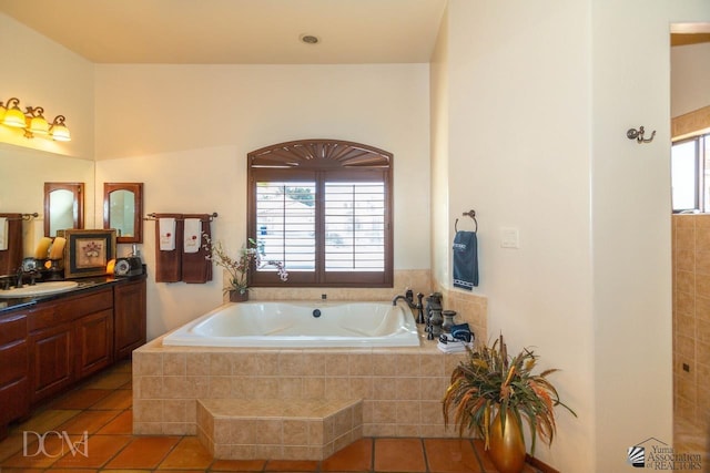 full bath featuring vanity, tile patterned flooring, and a garden tub