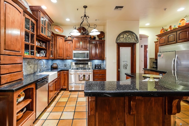 kitchen featuring visible vents, open shelves, arched walkways, a sink, and appliances with stainless steel finishes