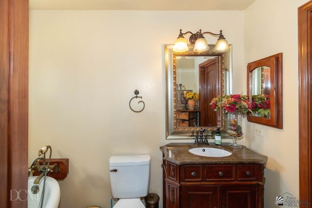 bathroom with toilet and vanity