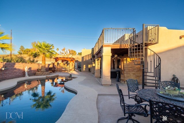 outdoor pool featuring stairs, outdoor dining area, fence, and a patio