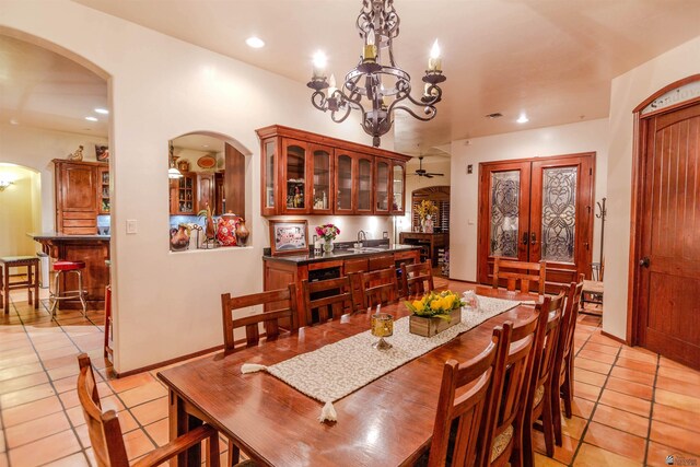 dining area with recessed lighting, arched walkways, ceiling fan with notable chandelier, and light tile patterned floors