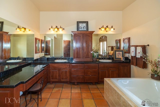 bathroom with a sink, tile patterned floors, double vanity, and a relaxing tiled tub