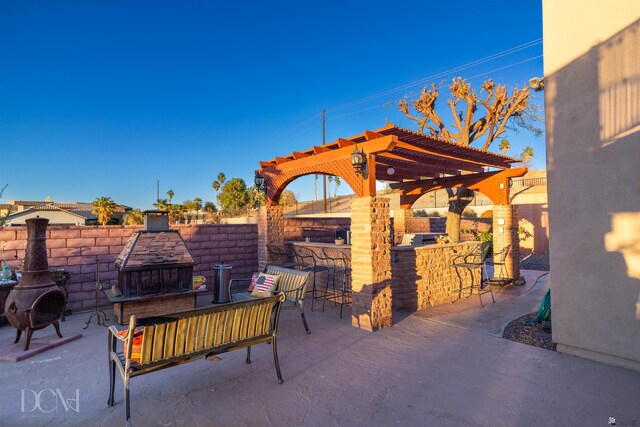 view of patio / terrace featuring outdoor dry bar and a pergola