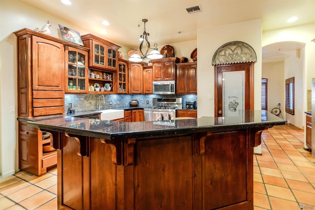 kitchen featuring a sink, appliances with stainless steel finishes, light tile patterned floors, and visible vents