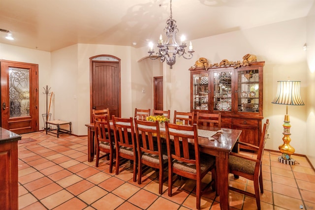 dining space with a notable chandelier and light tile patterned floors
