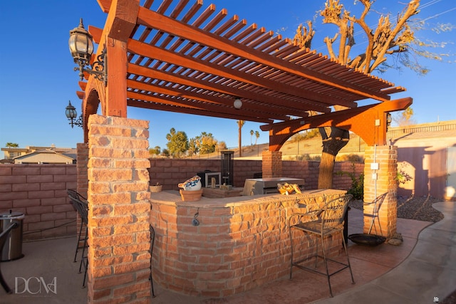 view of patio / terrace with a fenced backyard and outdoor dry bar