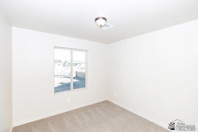 12546 E 51st Pl, Yuma, AZ 85367 - spare room featuring carpet floors, baseboards, and visible vents