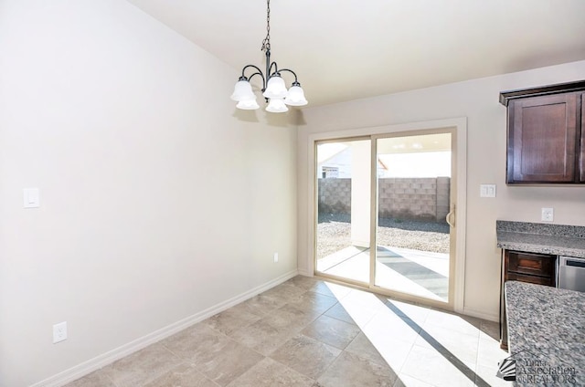 12546 E 51st Pl, Yuma, AZ 85367 - unfurnished dining area featuring baseboards and a chandelier