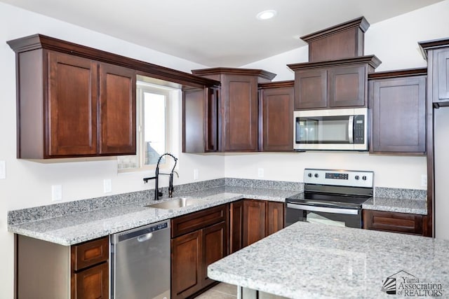 12546 E 51st Pl, Yuma, AZ 85367 - kitchen with dark brown cabinetry, appliances with stainless steel finishes, light stone countertops, a sink, and recessed lighting