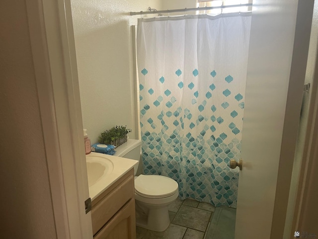 bathroom featuring vanity, a shower with curtain, and toilet