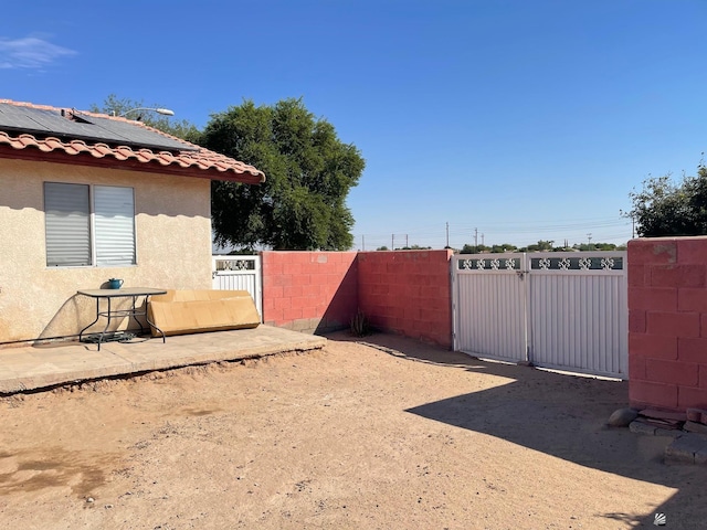 view of yard with fence and a gate