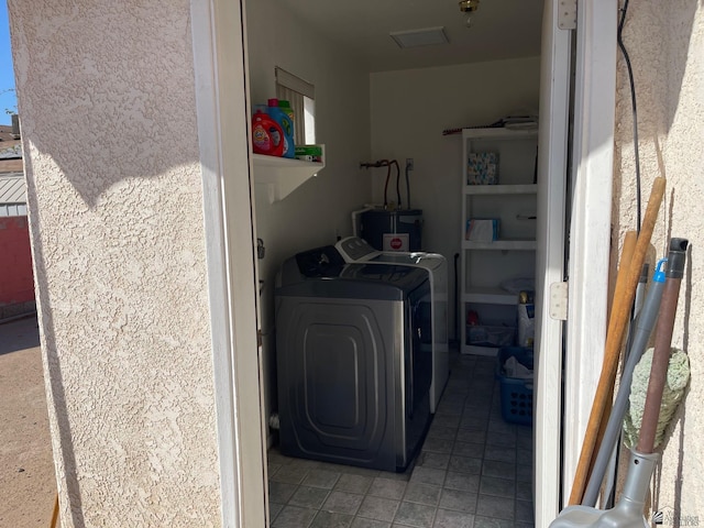washroom featuring tile patterned floors, laundry area, independent washer and dryer, and electric water heater