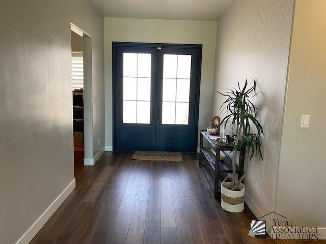4595 S Villa Serena Drive Model Home Not For Sale, Yuma, AZ 85365 - doorway to outside with baseboards, french doors, and dark wood-type flooring