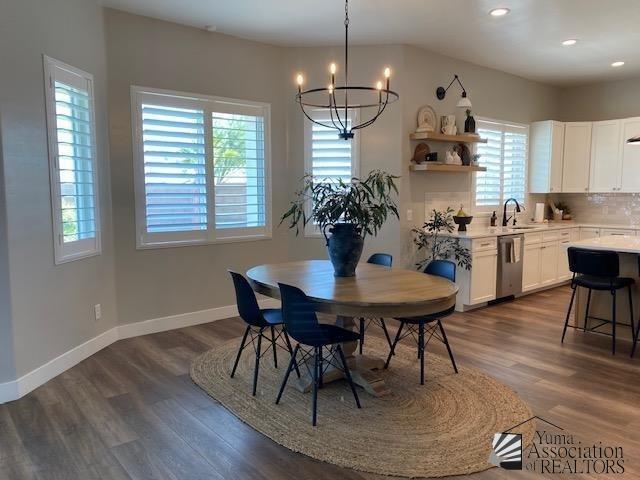 4595 S Villa Serena Drive Model Home Not For Sale, Yuma, AZ 85365 - dining area featuring dark wood-type flooring, recessed lighting, baseboards, and a chandelier