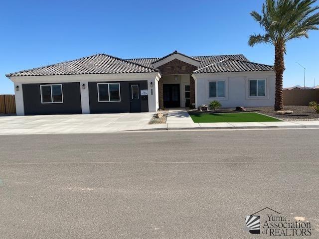 4595 S Villa Serena Drive Model Home Not For Sale, Yuma, AZ 85365 - view of front of home featuring fence, a tile roof, and stucco siding